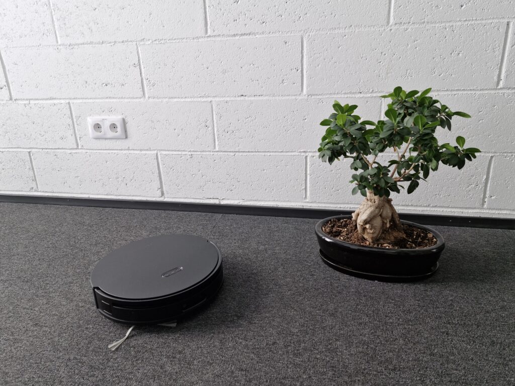 robot vacuum with a small plant